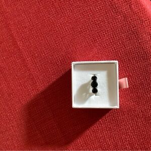 Black Three-Stone Ring in White Jewelry Box